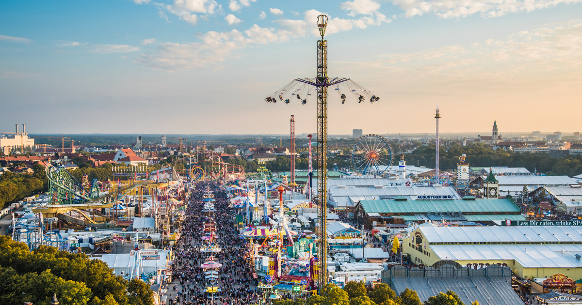 Crowds explore Oktoberfest with its many amusement rides and massive beer tents