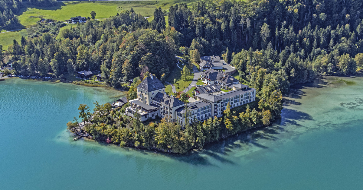 Schloss Fuschl in Austria surrounded by forest and lake