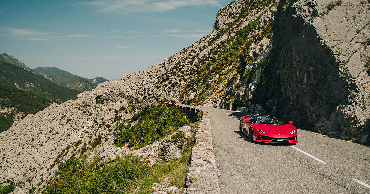 A red Lamborghini Huracan Spyder on a high country road in France