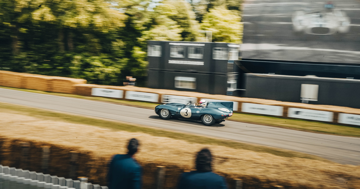 A Jaguar D Type with the number 3 racing at Goodwood