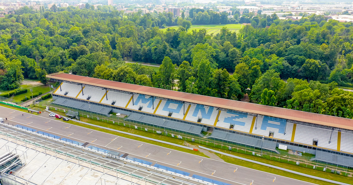 Stands at the Monza racetrack with the word ‘Monza’ patterned in blue on the white seats