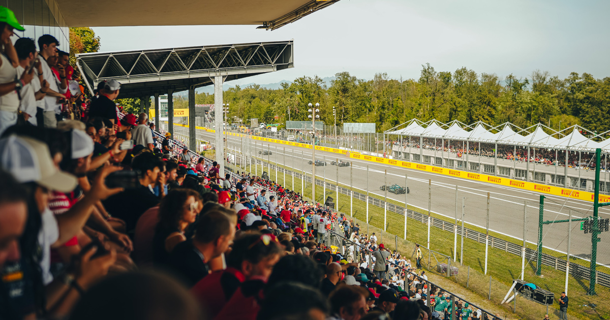 Crowd at Monza watching on as F1 cars speed down the home straight