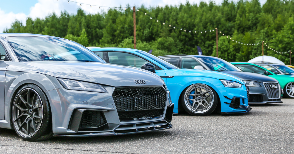 A collection of modern, modified Audis at an enthusiasts’ gathering