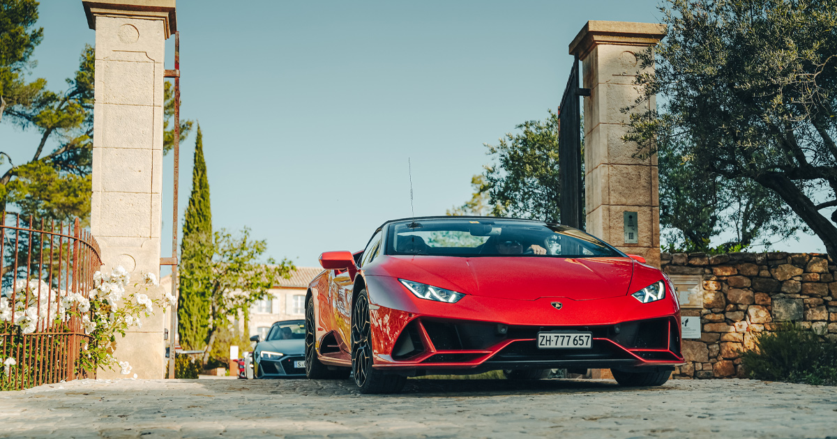 A red Lamborghini Huracan Spyder leads a convoy on an Ultimate Driving Tours experience