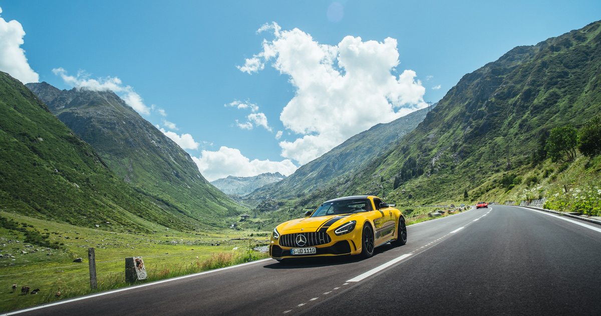 A yellow Mercedes AMG GTR in the Swiss Alps