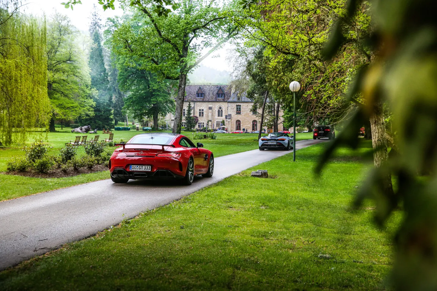 Mercedes and McLaren driving towards a five-star hotel in France on a supercar tour of Europe