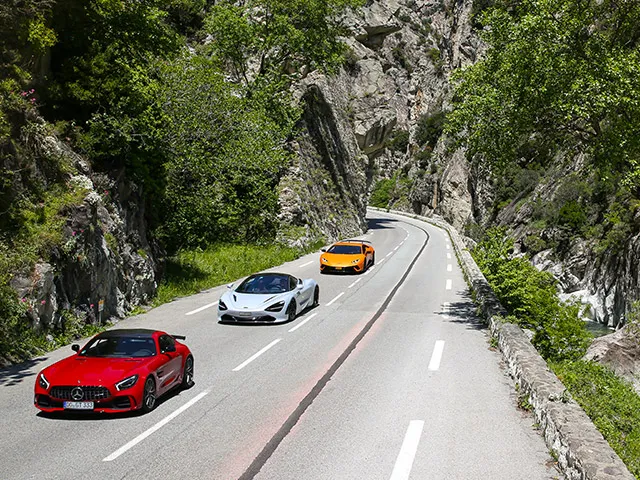 Red Ferrari climbing Mountain Road