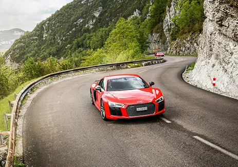 A supercar driving the best alpine roads in Switzerland on a luxury driving tour